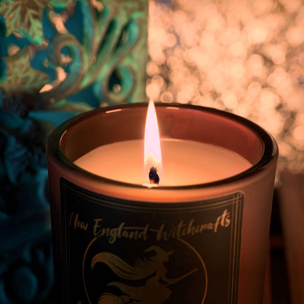 Image depicts a lit candle and the warm glow.