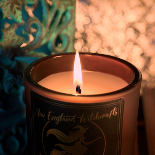 Image depicts a lit candle and the warm glow.
