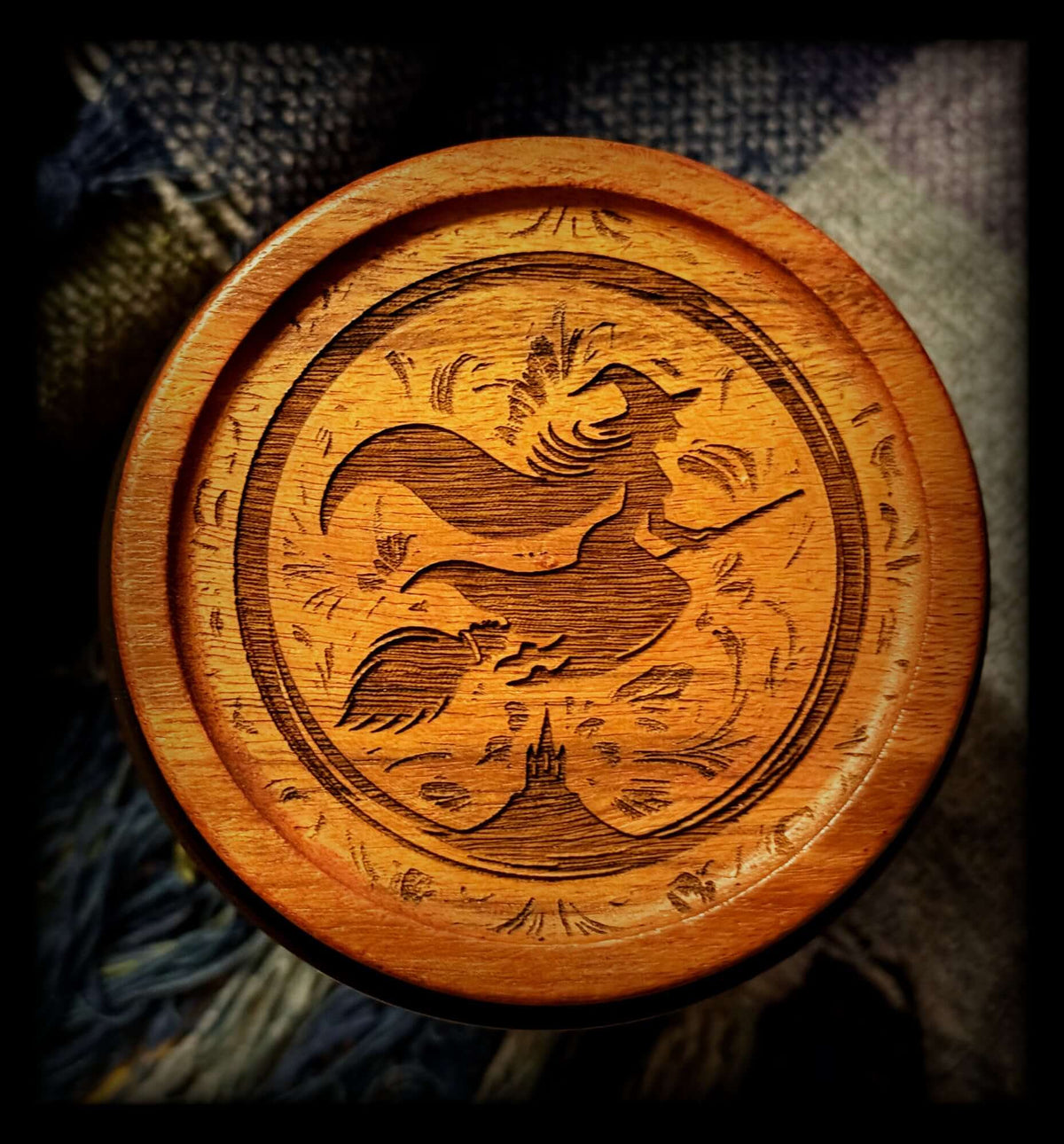 Image depicts an acacia wood lid engraved with a witch logo.